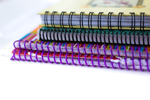 Stack Used Spiral Notebooks/Diaries, White Background