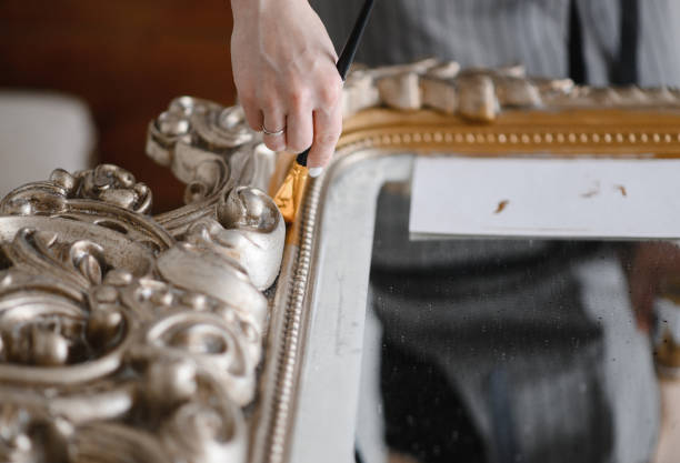 istock young woman repairs the frame for a mirror or a picture 1306910015