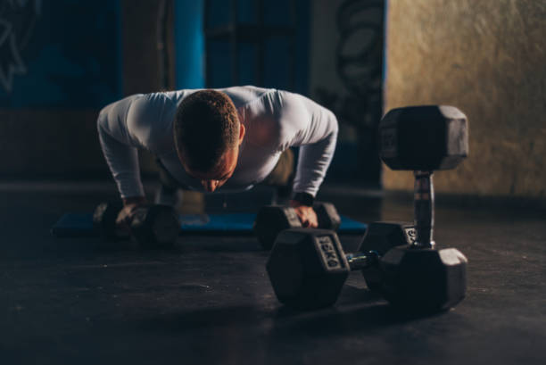 istock Man doing pushups in the gym 1306915248