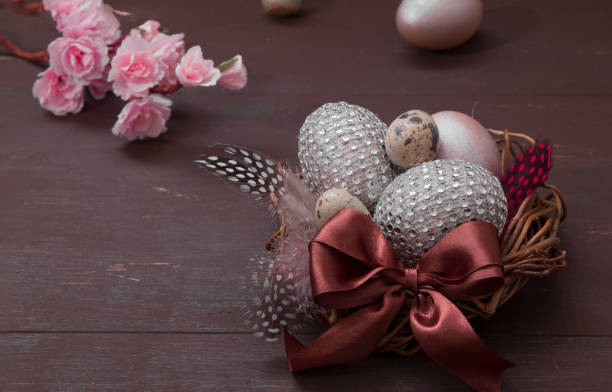 istock Happy Easter nest with eggs on a wooden background. Happy Easter greeting card with creative easter eggs and blossom flowers 1306916015