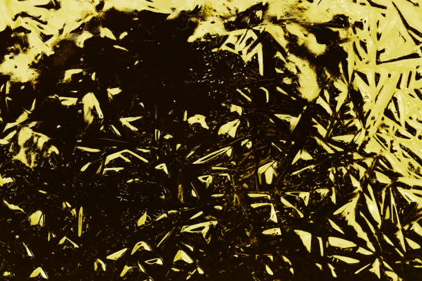 istock An abstract pattern in black and yellow has been created on frozen water 1306916769
