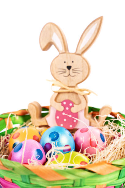 istock Easter bunny with colourful eggs with polka dots in a basket 1306918330