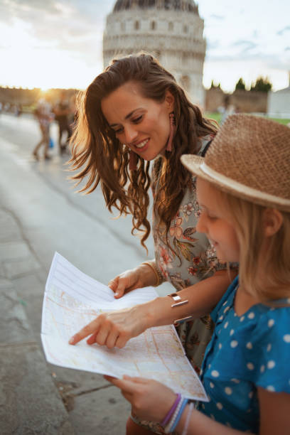 istock smiling modern mother and child with map 1306919021