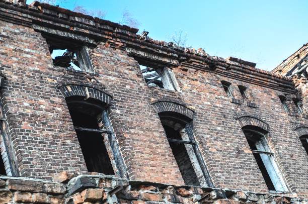 istock damaged windows in old building ruin, damaged brick wall abandoned 1306920952