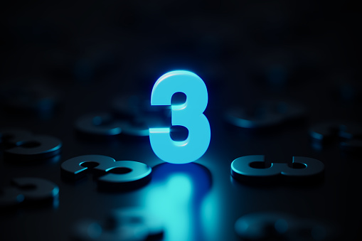 Blue number three glowing amid black number threes on black background. Horizontal composition with copy space.