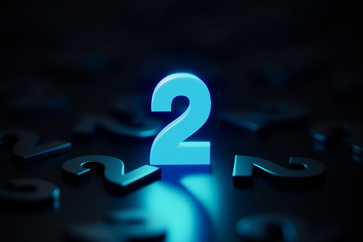 Blue number two glowing amid black number twos on black background. Horizontal composition with copy space.