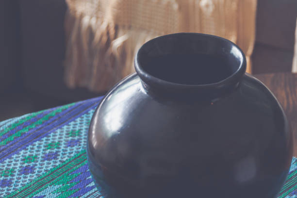istock Hand made wool textile and clay vase background 1306936172