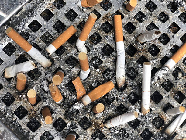 istock Cigarette butts in tray 1306939317