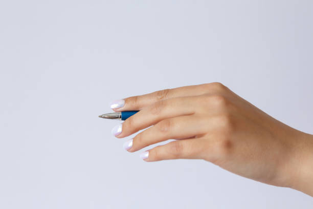 istock Gesture and sign, hand holding a pen on a white background 1306941813