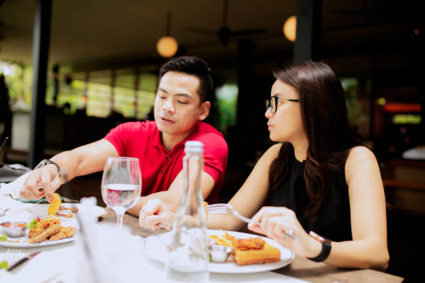 istock young couple lunch together at restaurant 1306943759