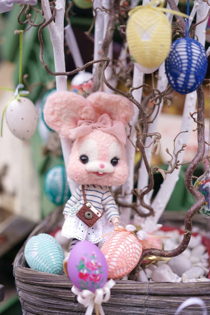 istock Happy Easter. Cute Easter Bunny doll decorated for Easter eggs hunt festival. Colorful decorative Easter eggs. Soft focus. 1306944715