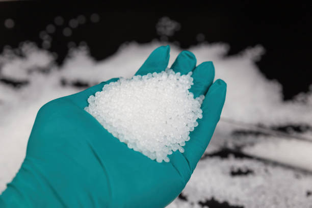 istock White plastic beads on black background, Polymers bead or polymer resin, polymer pallet, Product from petrochemical plants. granules polymer, 1306953021