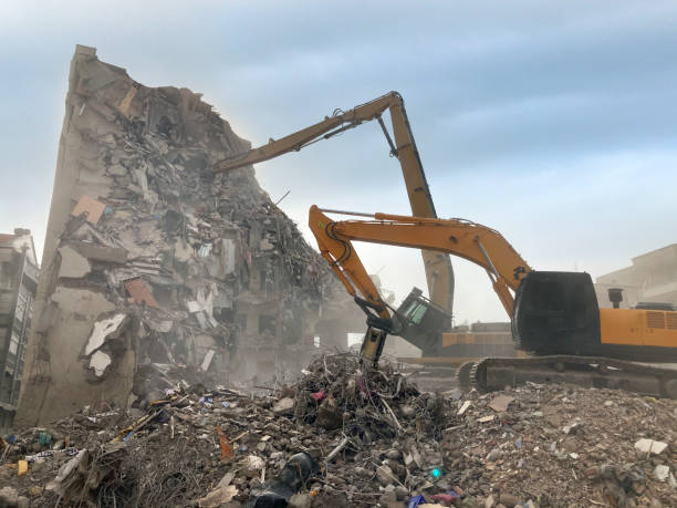 istock Earth digger demolishing a building 1306957945