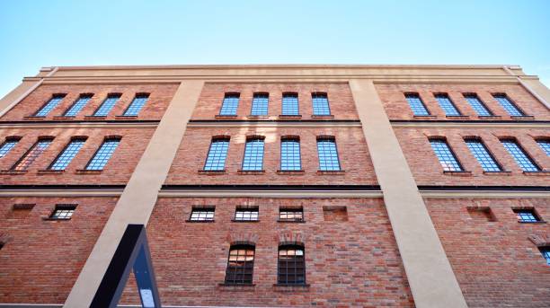 istock Revitalized red brick building and modern office building. 1306959677