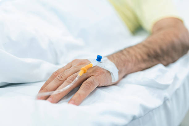 istock Cropped image of IV drip on patient hand. 1306961782