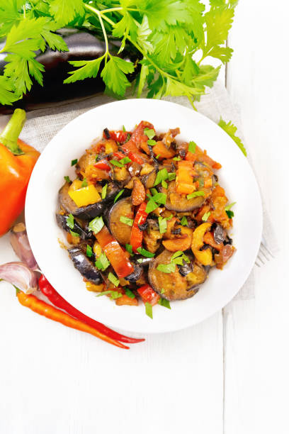 istock Ragout with eggplant and pepper on light board top 1306963073