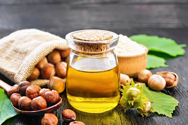 istock Oil hazelnut in jar on wooden board 1306964084