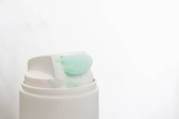 Green shaving foam with the can closeup, copy space