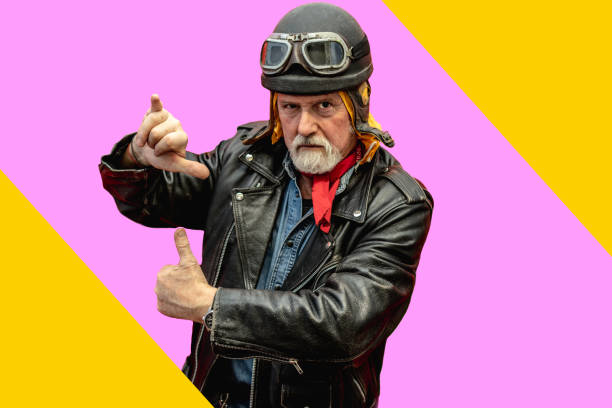 istock Elderly man dressing as a biker having fun on a multicolor background 1306967091