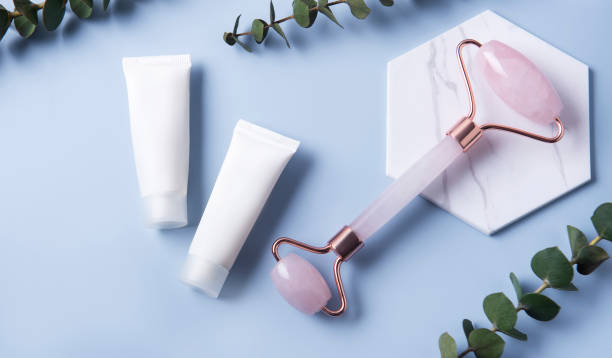istock Cosmetic products, cream tubes and  face roller 1306969237