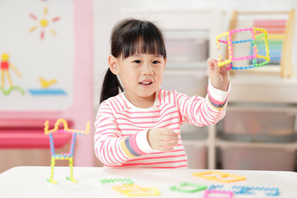 istock Young Girl Playing Creative 3D Shape Toy For Homeschooling 1306969440