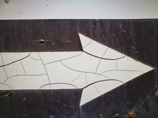 istock Crack on white arrow symbol on black background 1306971462