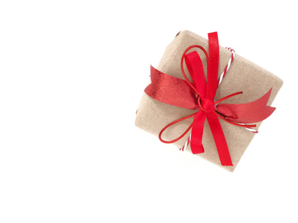 istock A brown gift box tied with a red bow and ribbon isolated on a white background. Top view flat lay. 1306974090
