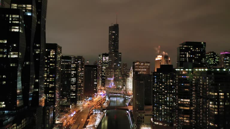 Urban Chicago City and Chicago River at Night in Winter. Aerial View. USA