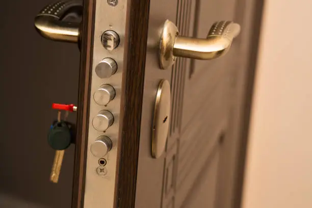 Closeup shot of modern door lock with a key. Space for text