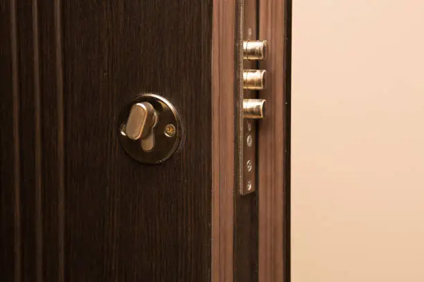 Photo of Contemporary metal door with a lock closeup