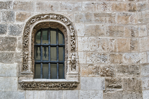 Stone window and iron bars of Gothic architecture in the conventual church of San Pablo, Valladolid