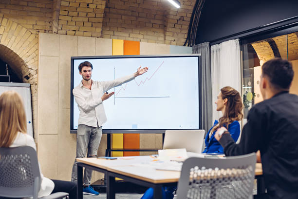 istock Businessman showing growth graph to colleagues 1306977800