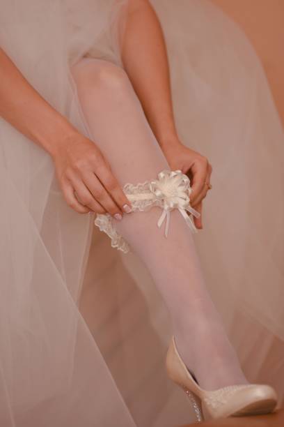 istock the bride puts a garter on her leg 1306982280