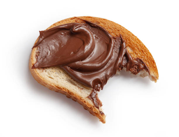 istock toasted bitten bread slice with chocolate hazelnut cream isolated on white background, top view 1306985435
