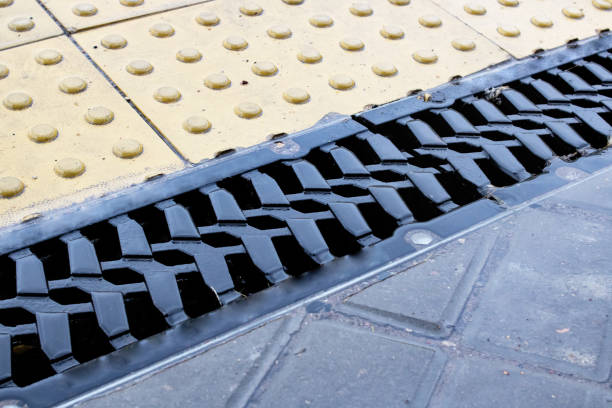 istock Rain grate on the sidewalk in the rain 1306995691