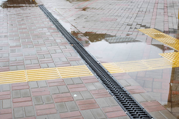 Rain grate on the sidewalk in the rain close up
