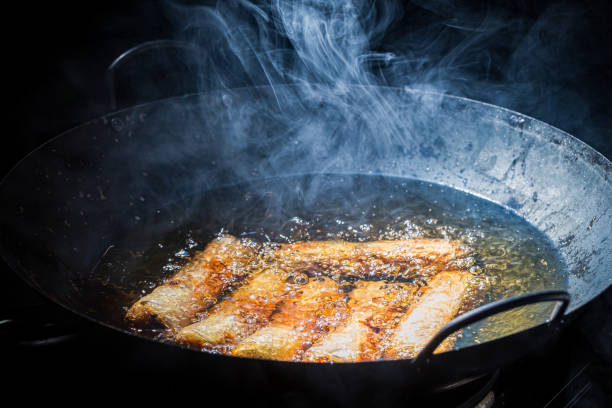 istock Spring rolls frying in black wok. Vietnamese cuisine. 1306997655