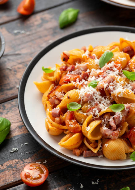 istock Conchiglie alla Amatriciana pasta with pancetta bacon, tomatoes and pecorino cheese. Healthy Italian food 1306997708