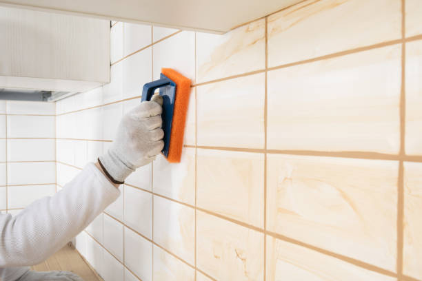 istock a ceramic tile laying master wipes the seams with a special sponge 1306998073