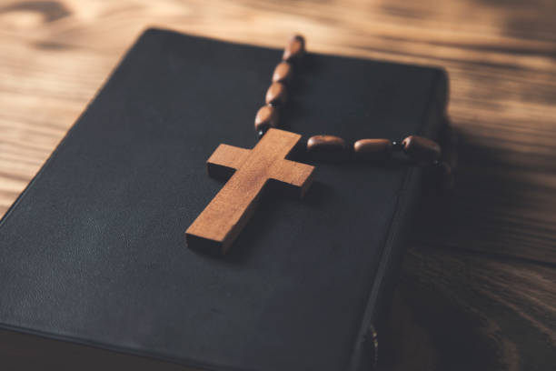 istock wooden cross on the Holy Bible 1307002816