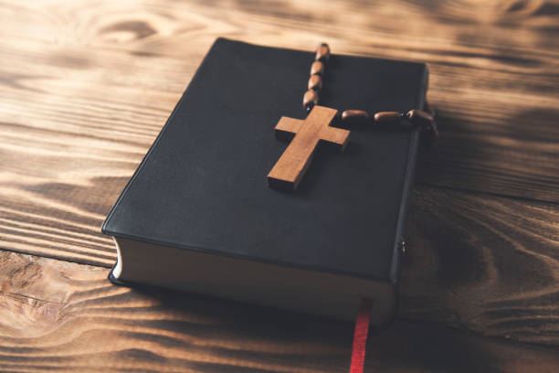 istock wooden cross on the Holy Bible 1307002820