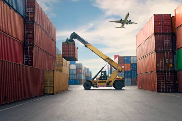 airplane flying above container port. - recipiente imagens e fotografias de stock