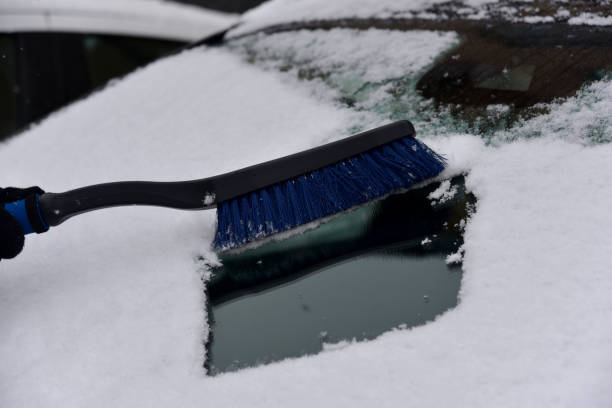 istock Removing snow from car windshield. Clean car window in winter from snow. 1307002936