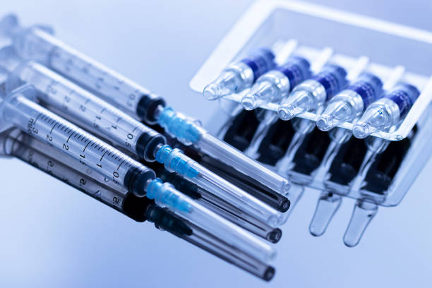 istock Ampoules in a row and syringes with needle 1307003002