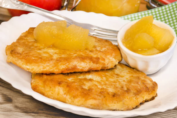 Potato fritters with apple sauce close up Potato fritters with apple sauce close up apple compote stock pictures, royalty-free photos & images