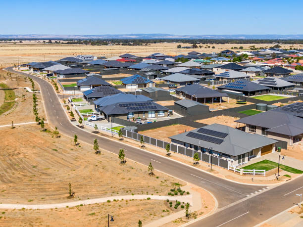 Aerial view, new rural housing development being built on former quality food-producing farmland. Aerial view, new rural housing development being built on former quality food-producing farmland and next to existing agricultural activity with farmland and rolling hills in background urban sprawl stock pictures, royalty-free photos & images