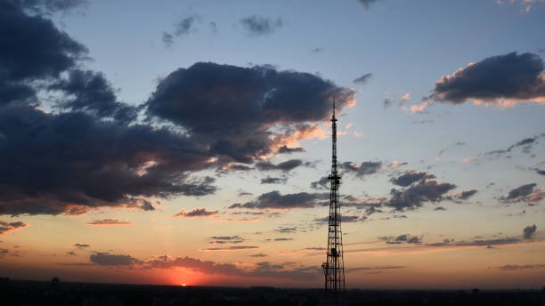 istock Blur silhouette of communication tower with sunset cloudscape skyline 1307005247