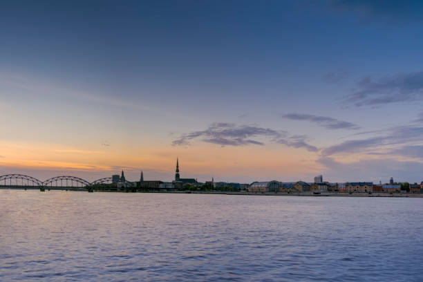 istock Night view on the illuminated riverside with reflection on the river in Riga 1307005973