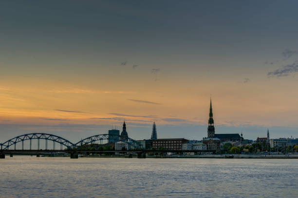 istock Night view on the illuminated riverside with reflection on the river in Riga 1307005977