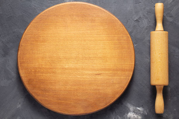 istock Pizza or bread cutting board for homemade baking on table. Food recipe concept 1307006452